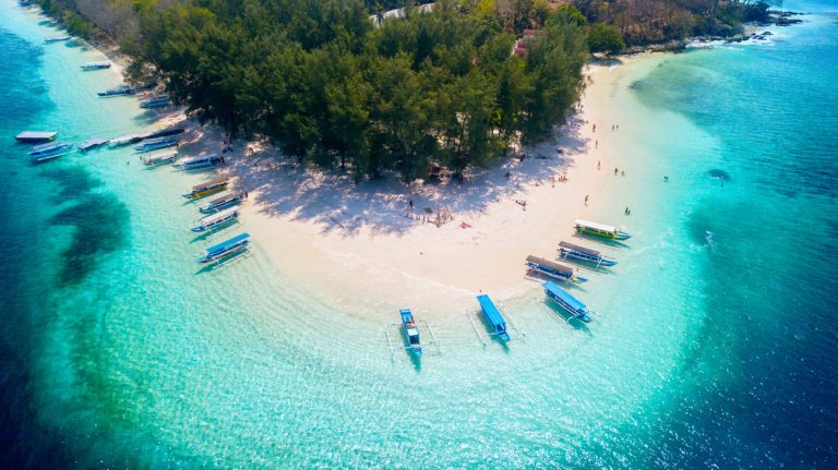 Bali - Indonesia. April 09, 2019: Aerial view of traditional boats anchored on the Gili Rengit beach in Lombok, Indonesia